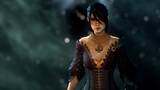 A raven-haired woman in period costume closes her eyes as some kind of magical force swirls around her. It's Morrigan from Dragon Age.